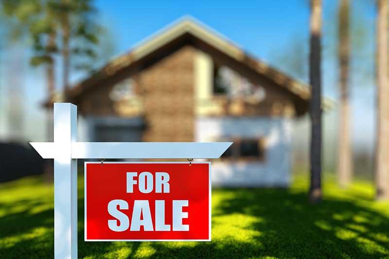 For Sale sign in front of a house.