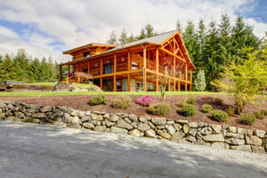 The exterior of a beautiful log cabin.