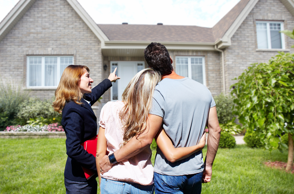 Real Estate Agent helping a couple look at a home