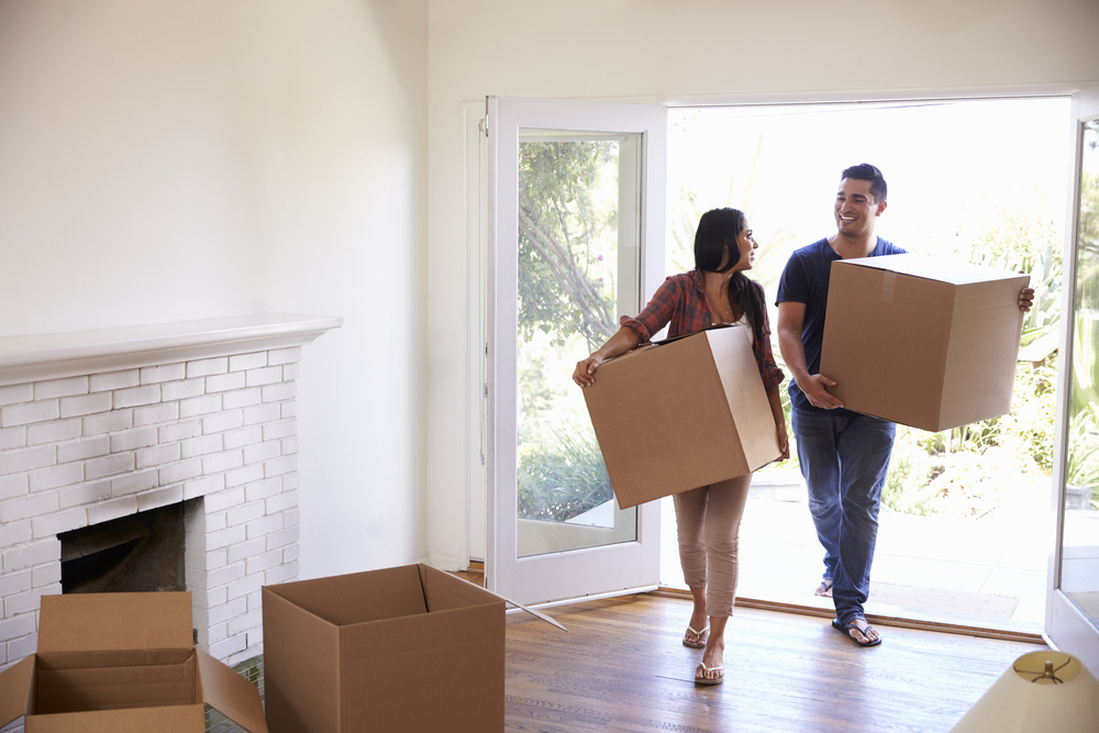 couple with boxes on closing day